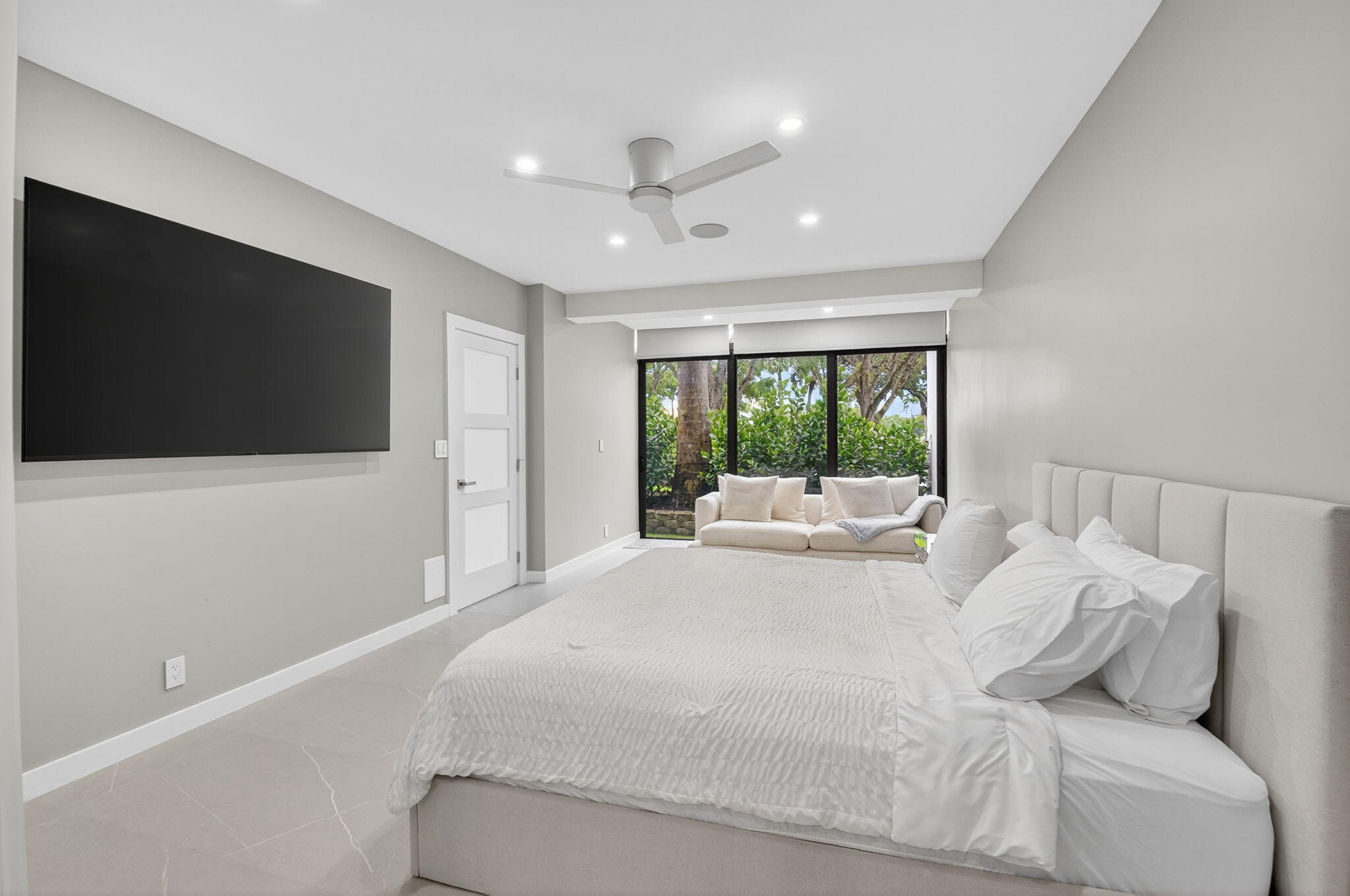 7847 Lakeside Boulevard, Unit 1014 Boca Raton, FL 33434 - Photo 22 of 53 a bed room with a bed a television and a large window