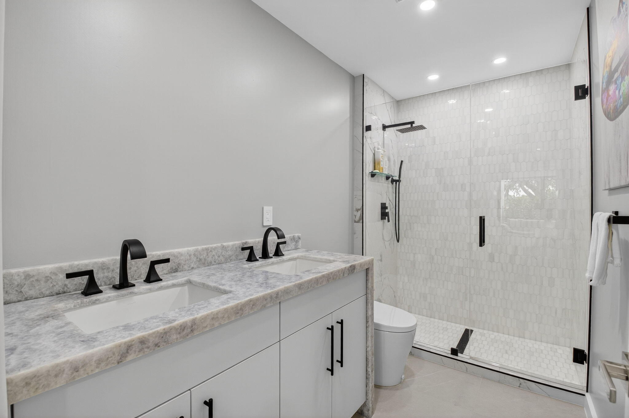 7847 Lakeside Boulevard, Unit 1014 Boca Raton, FL 33434 - Photo 24 of 53 a bathroom with a granite countertop sink a toilet a mirror and shower