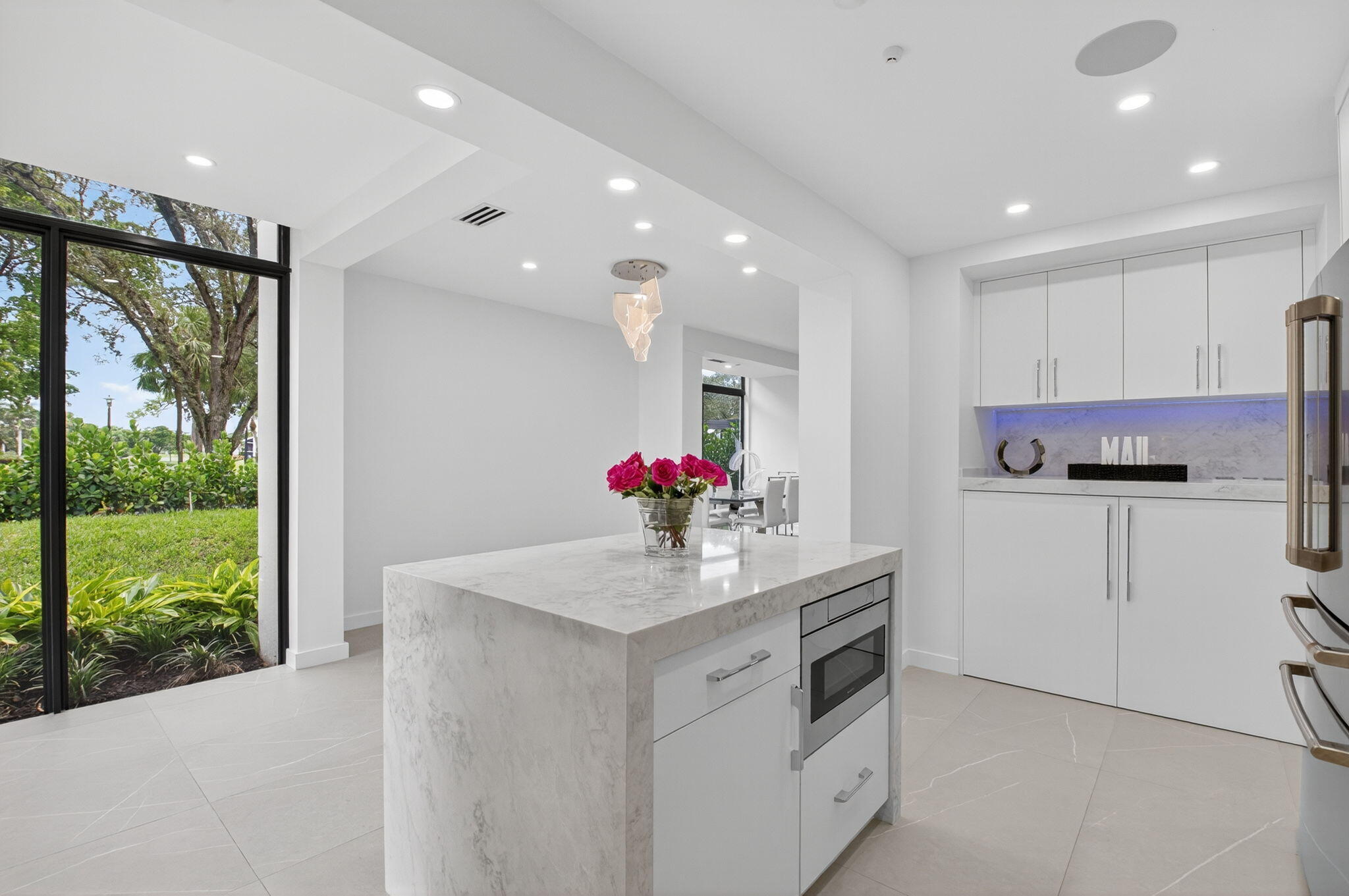 7847 Lakeside Boulevard, Unit 1014 Boca Raton, FL 33434 - Photo 6 of 53 a kitchen with kitchen island a sink stainless steel appliances and cabinets