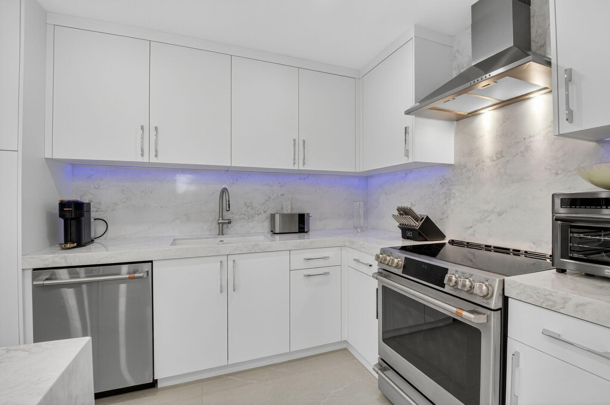 7847 Lakeside Boulevard, Unit 1014 Boca Raton, FL 33434 - Photo 10 of 53 a kitchen with white cabinets and appliances