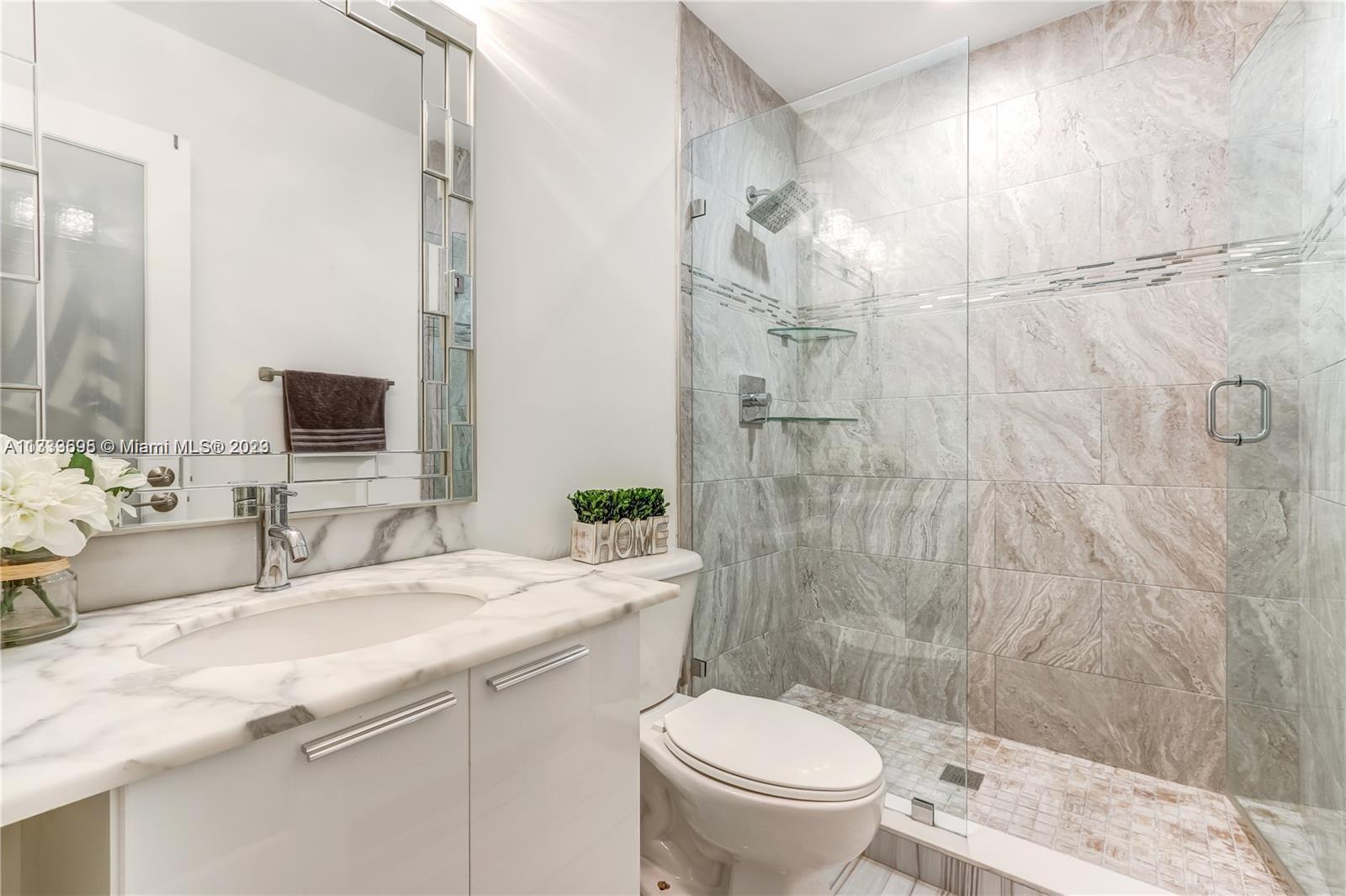 12015 Bird Road Miami, FL 33175 - Photo 11 of 16 a bathroom with a sink toilet and shower