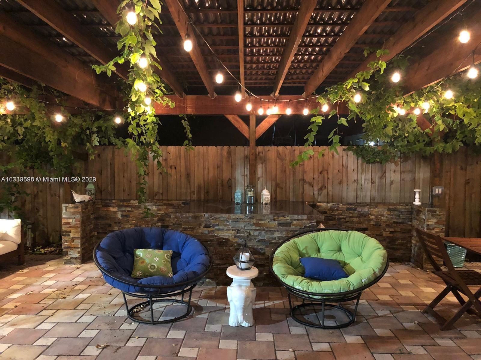 12015 Bird Road Miami, FL 33175 - Photo 13 of 16 a view of an outdoor sitting area in a backyard