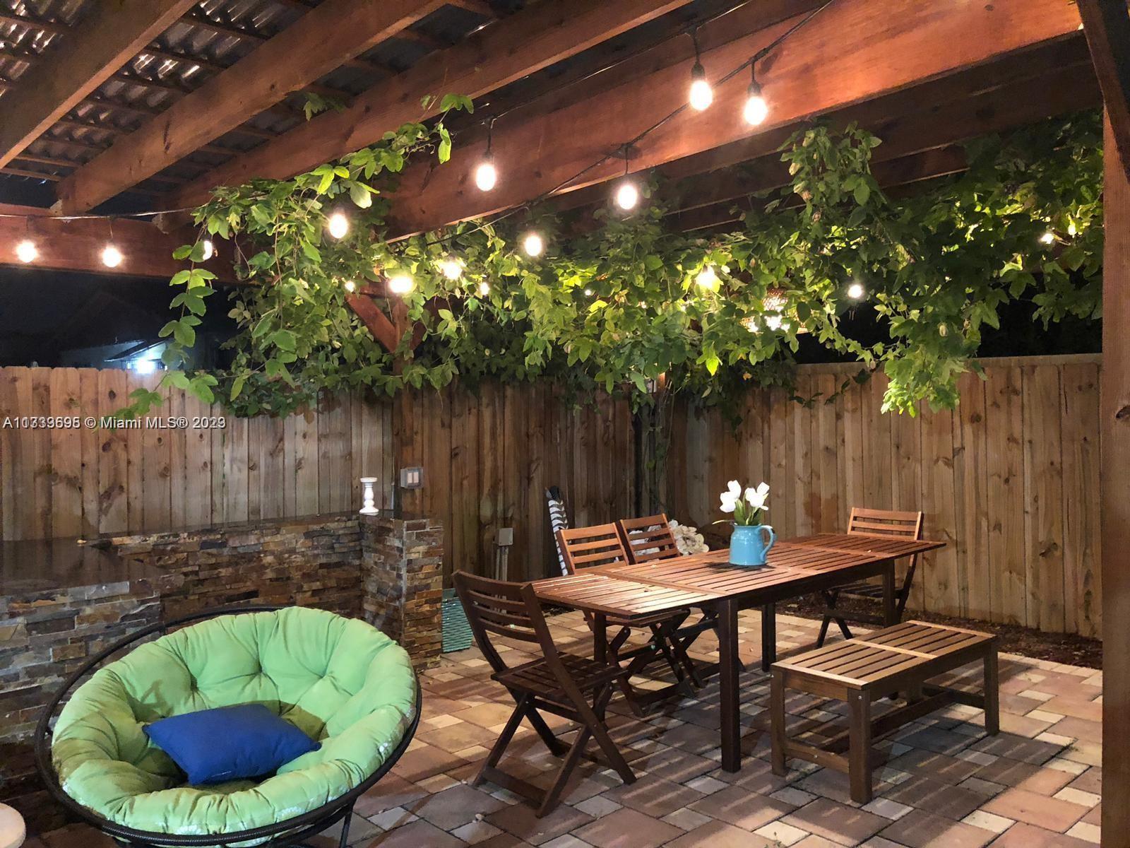 12015 Bird Road Miami, FL 33175 - Photo 15 of 16 a view of a tables and chairs in patio