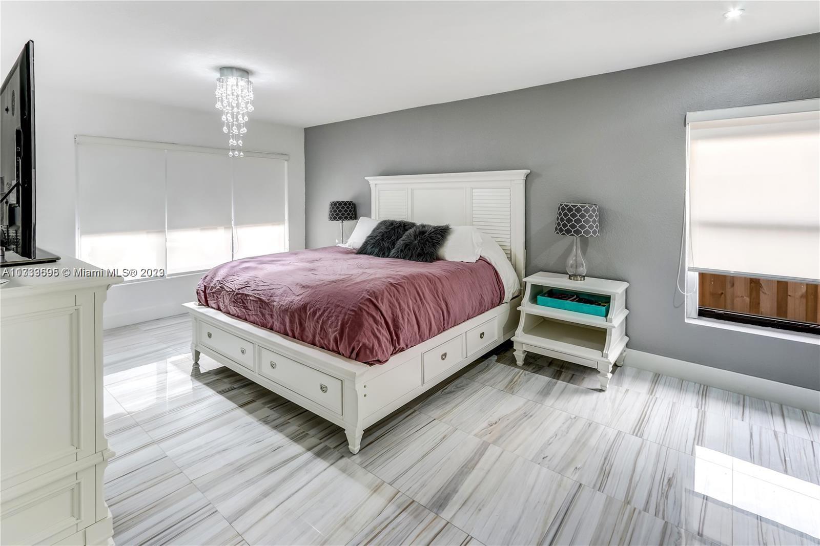 12015 Bird Road Miami, FL 33175 - Photo 6 of 16 a spacious bedroom with a bed and window