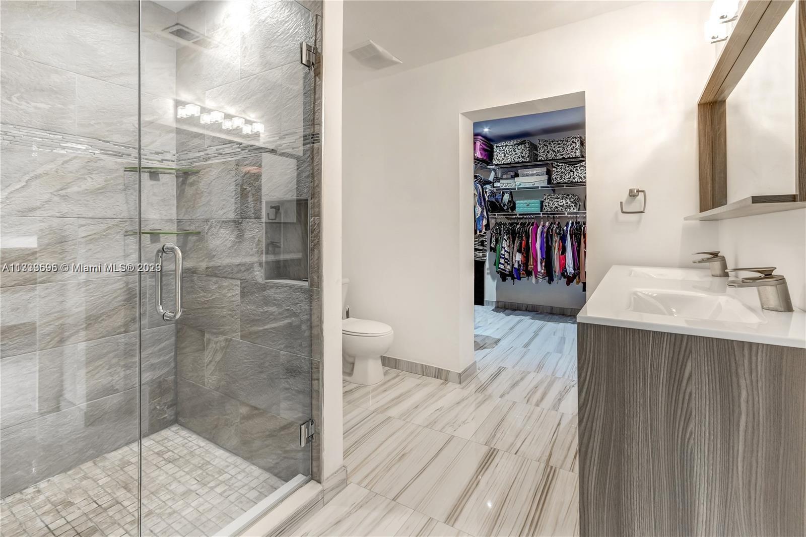 12015 Bird Road Miami, FL 33175 - Photo 7 of 16 a bathroom with a sink a toilet and shower