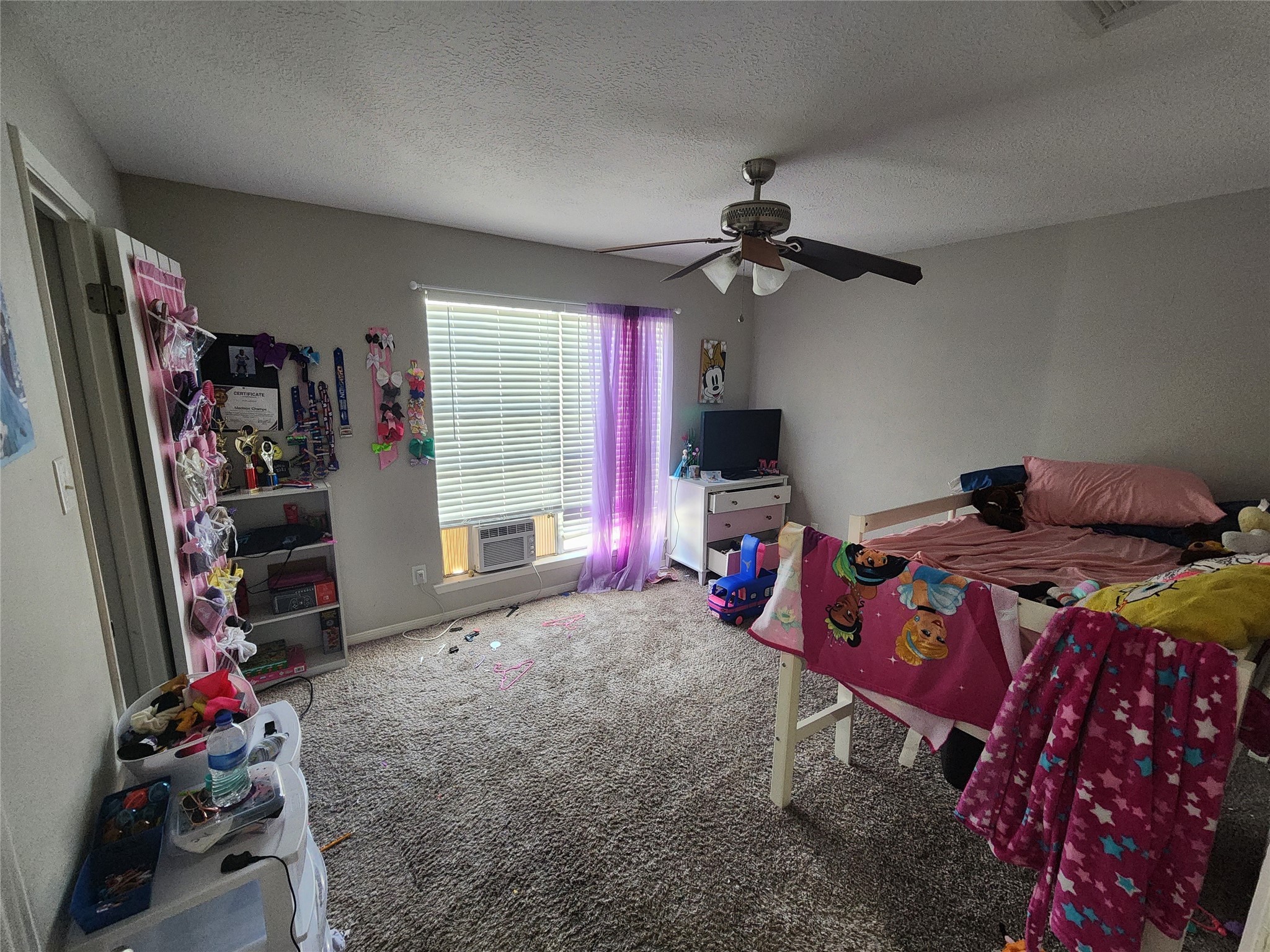 517 5th Street, Unit 4 Humble, TX 77338 - Photo 11 of 36 a bedroom with a bed a flat screen tv and a chandelier