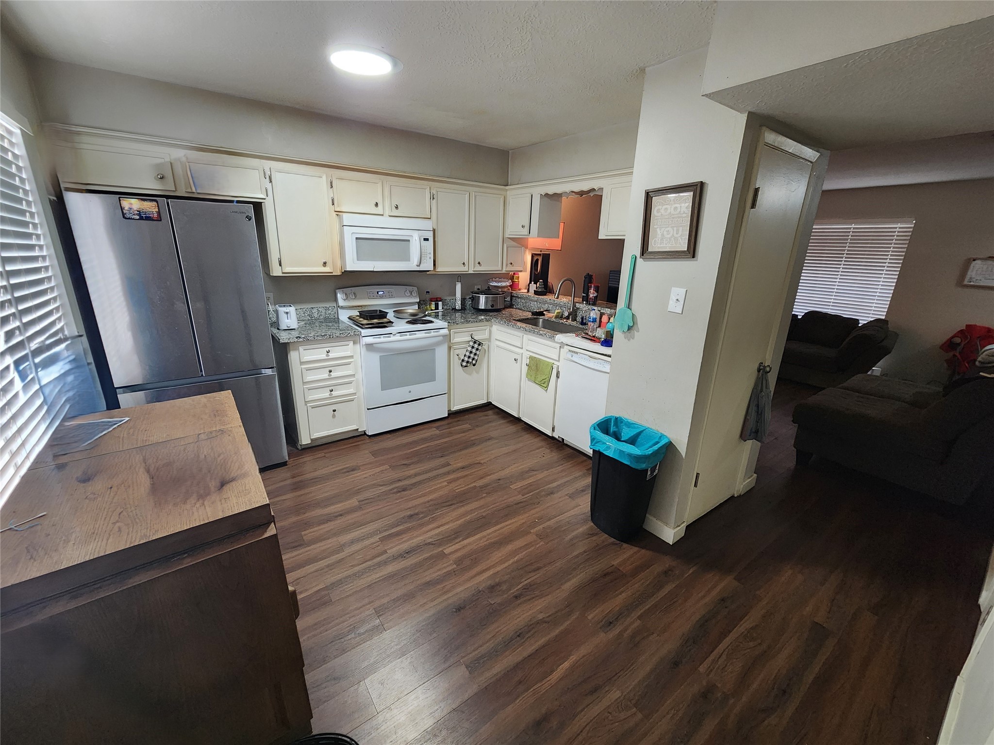 517 5th Street, Unit 4 Humble, TX 77338 - Photo 17 of 36 a kitchen with refrigerator cabinets and wooden floor