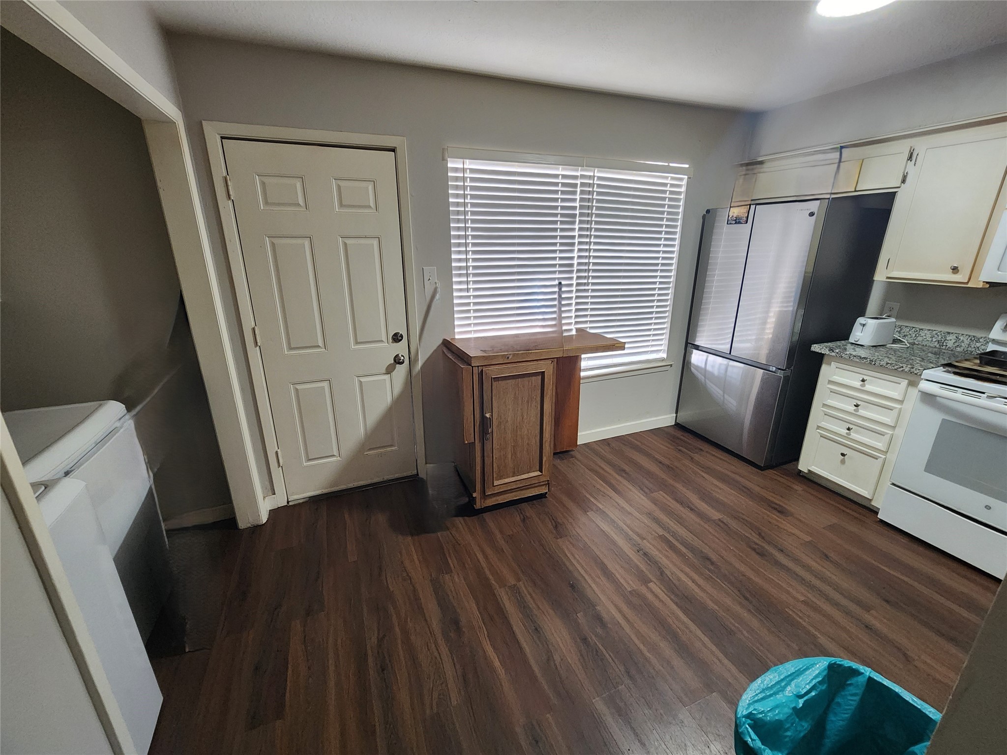 517 5th Street, Unit 4 Humble, TX 77338 - Photo 19 of 36 a kitchen with a wooden floor and a refrigerator