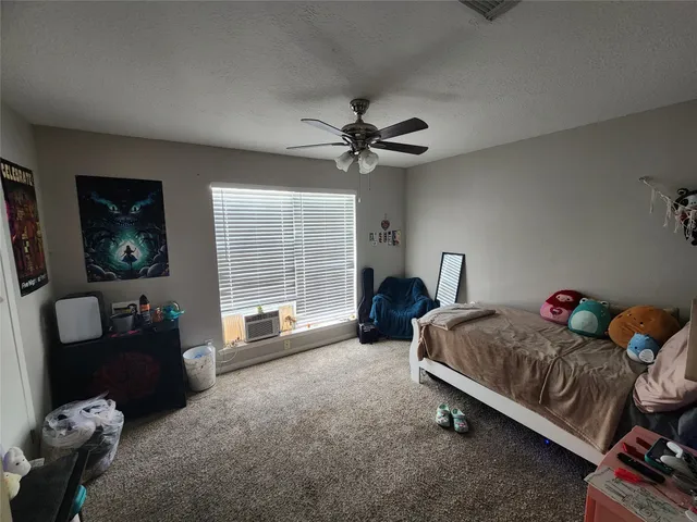a bedroom with furniture and a window