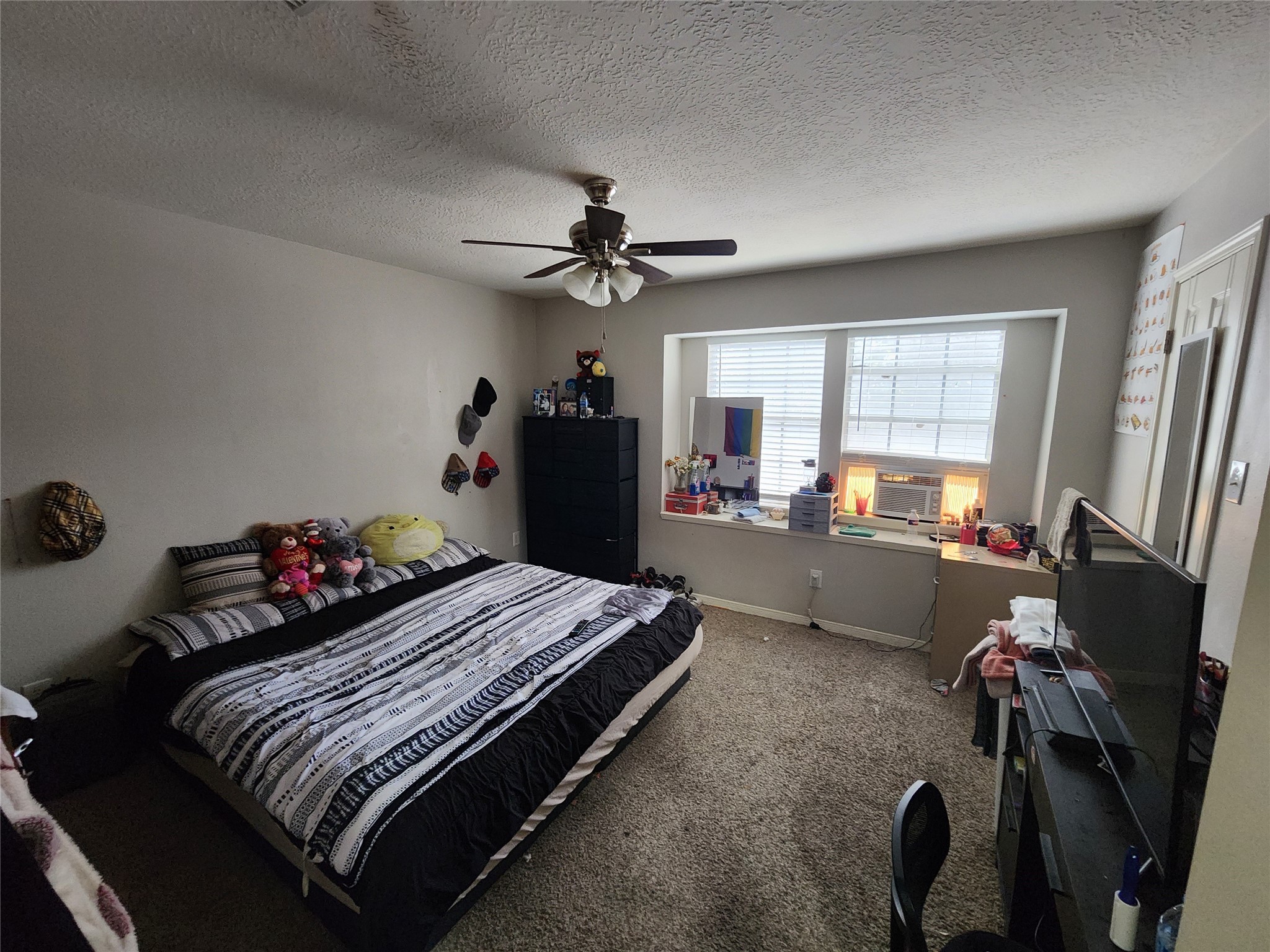 517 5th Street, Unit 4 Humble, TX 77338 - Photo 21 of 36 a room with a bed and a chandelier