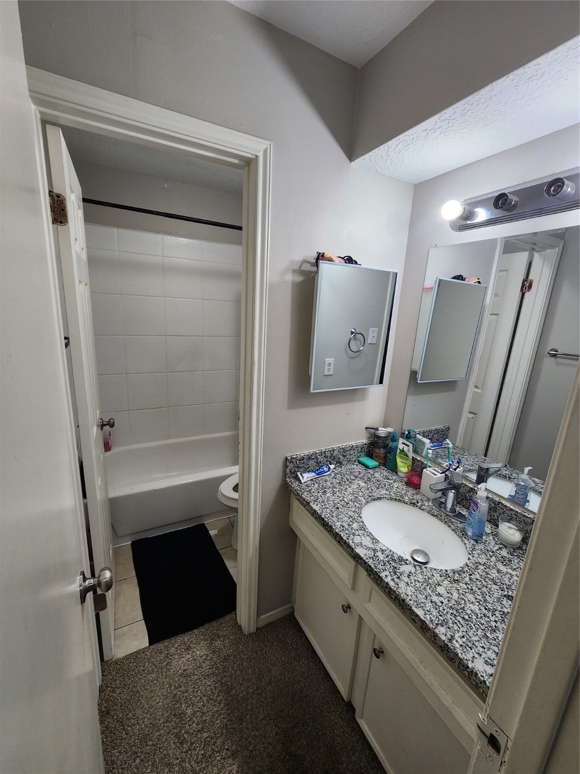 517 5th Street, Unit 4 Humble, TX 77338 - Photo 22 of 36 a bathroom with a granite countertop sink and a mirror