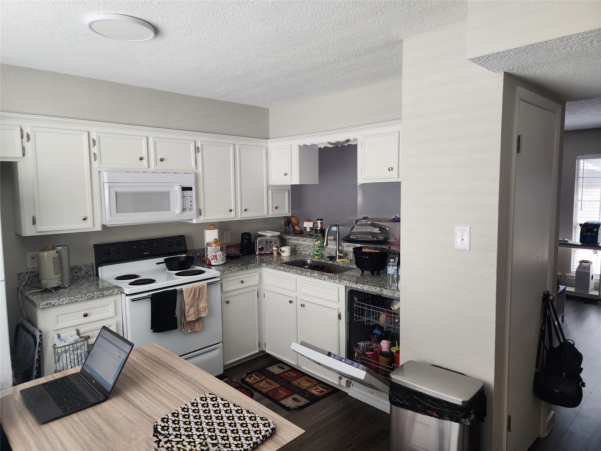 517 5th Street, Unit 4 Humble, TX 77338 - Photo 25 of 36 a kitchen with a sink stove and white cabinets
