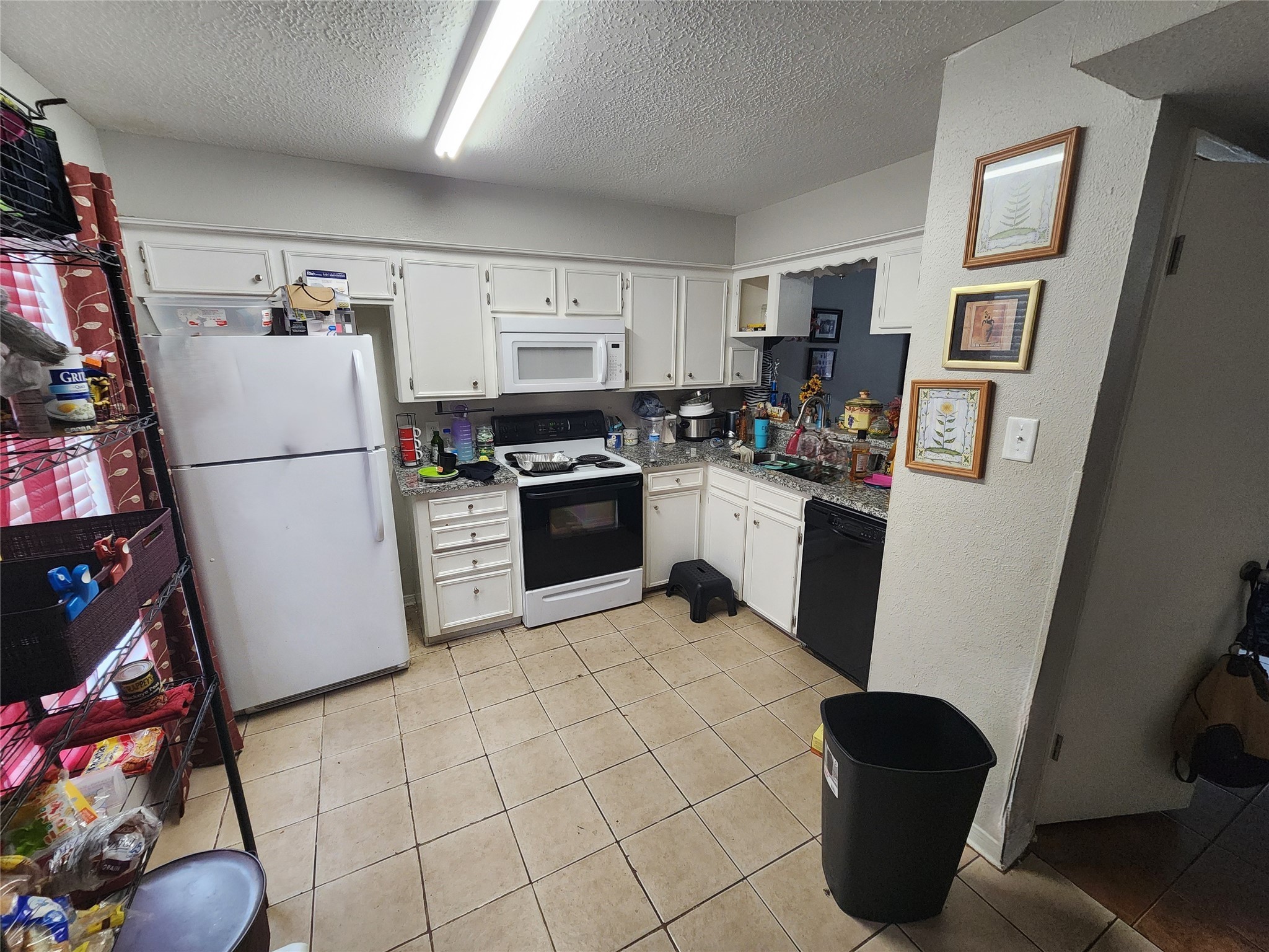 517 5th Street, Unit 4 Humble, TX 77338 - Photo 9 of 36 a kitchen with stainless steel appliances granite countertop a refrigerator a stove top oven a sink and dishwasher