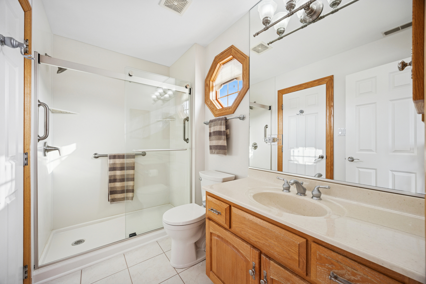 13773 Steeples Road Lemont, IL 60439 - Photo 26 of 30 a bathroom with a sink a toilet and a shower