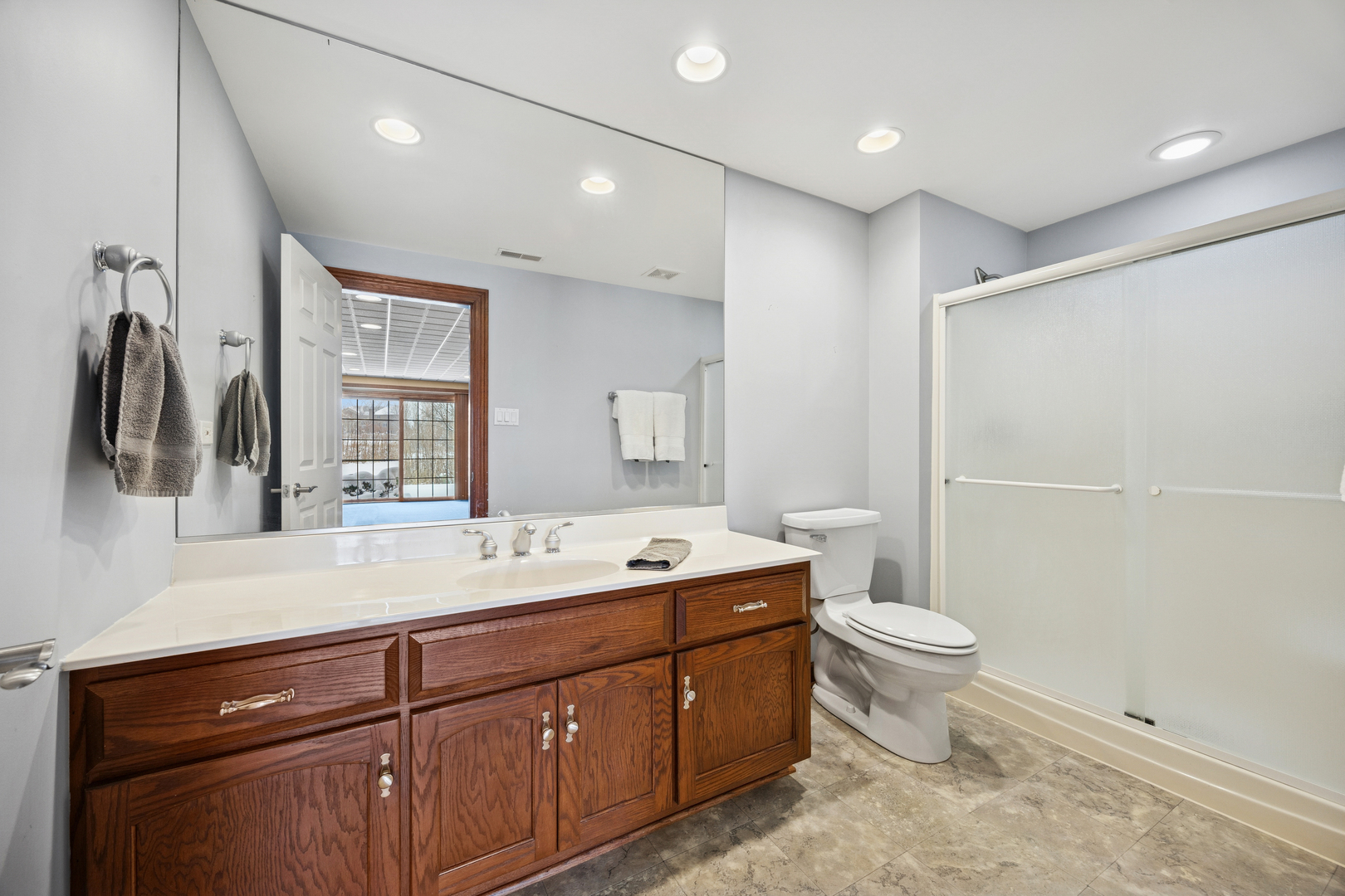 13773 Steeples Road Lemont, IL 60439 - Photo 30 of 30 a spacious bathroom with a toilet sink and mirror