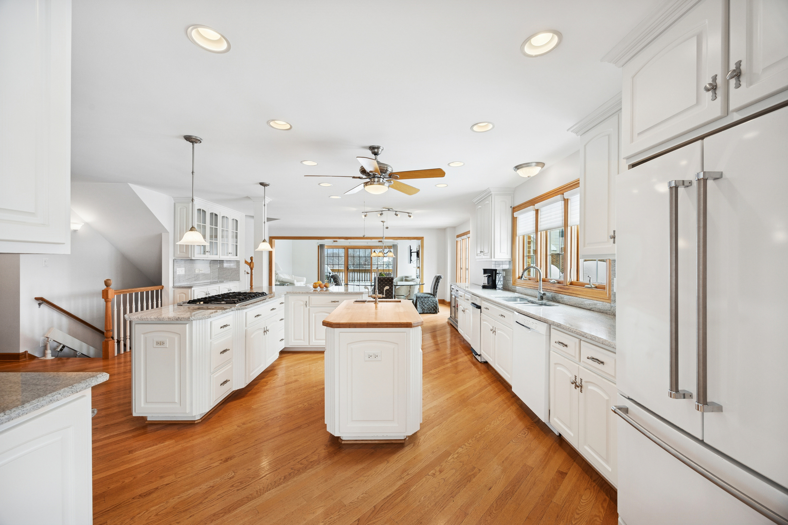 13773 Steeples Road Lemont, IL 60439 - Photo 4 of 30 a large kitchen with white cabinets and stainless steel appliances