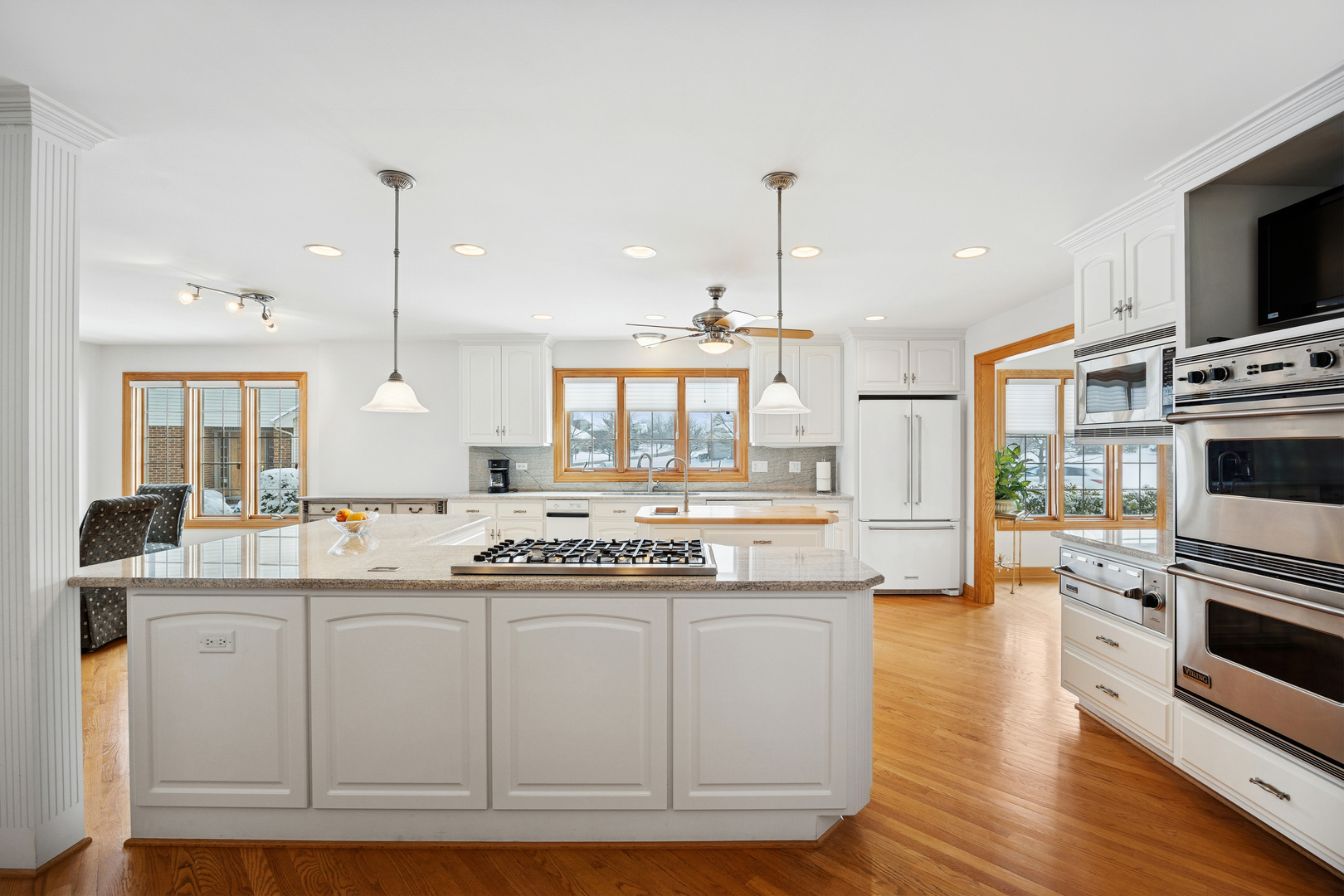 13773 Steeples Road Lemont, IL 60439 - Photo 7 of 30 a kitchen with stainless steel appliances granite countertop a stove and a sink