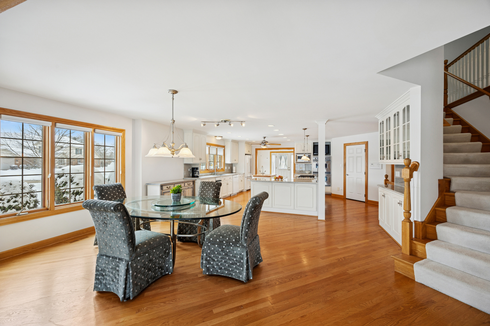 13773 Steeples Road Lemont, IL 60439 - Photo 9 of 30 a dining room with furniture a chandelier and wooden floor