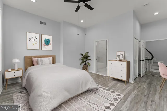 a spacious bedroom with a bed and a dresser