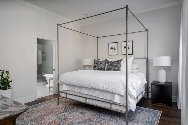 a bedroom with a bed and a potted plant