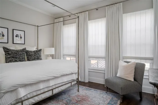 a bedroom with furniture and a large window