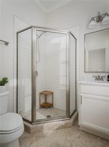 a bathroom with a shower a toilet and a sink