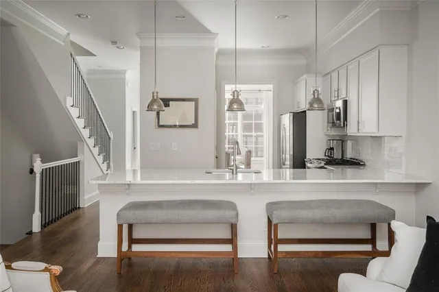 a living room with furniture and a painting on the wall