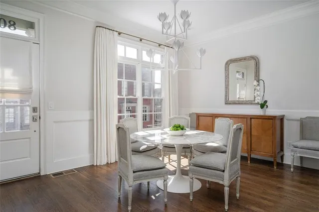 a view of a dining room with furniture and wooden floor