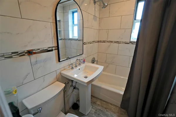 a bathroom with a sink toilet and tub