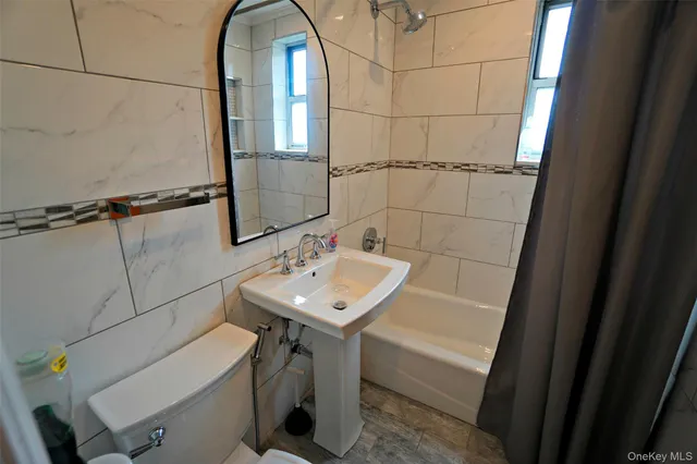 a bathroom with a sink toilet and tub
