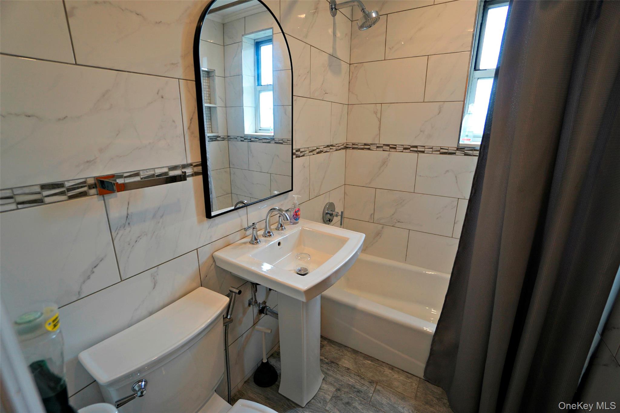7281 113th Street, Unit 5F Queens, NY 11375 - Photo 11 of 22 a bathroom with a sink toilet and tub