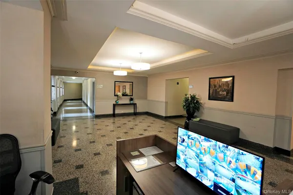 a living room with furniture and a baby crib