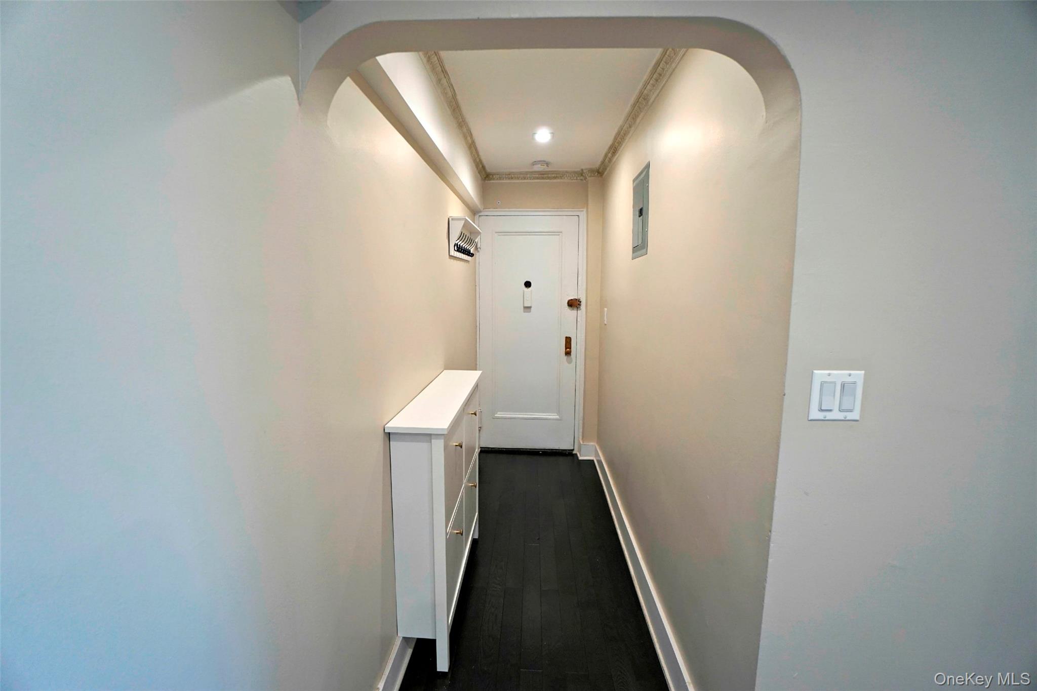 7281 113th Street, Unit 5F Queens, NY 11375 - Photo 2 of 22 a view of a hallway with wooden floor and staircase