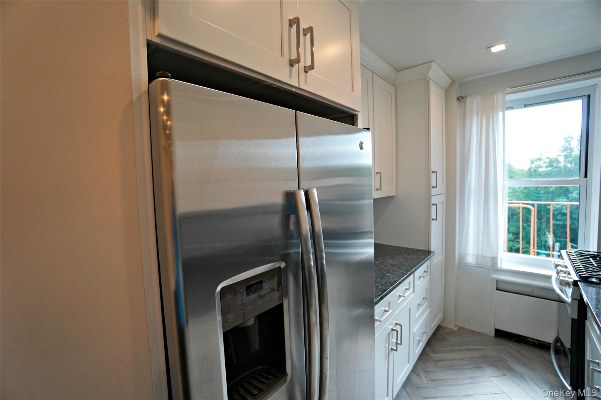 7281 113th Street, Unit 5F Queens, NY 11375 - Photo 5 of 22 a kitchen with stainless steel appliances granite countertop a refrigerator and a sink