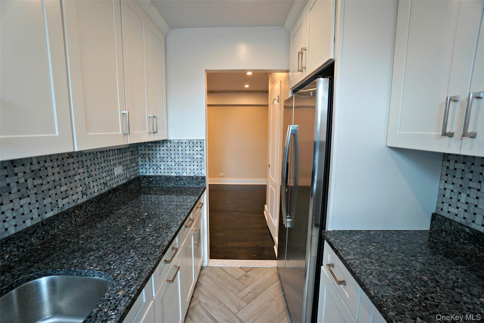 7281 113th Street, Unit 5F Queens, NY 11375 - Photo 7 of 22 a kitchen with granite countertop a refrigerator and a sink