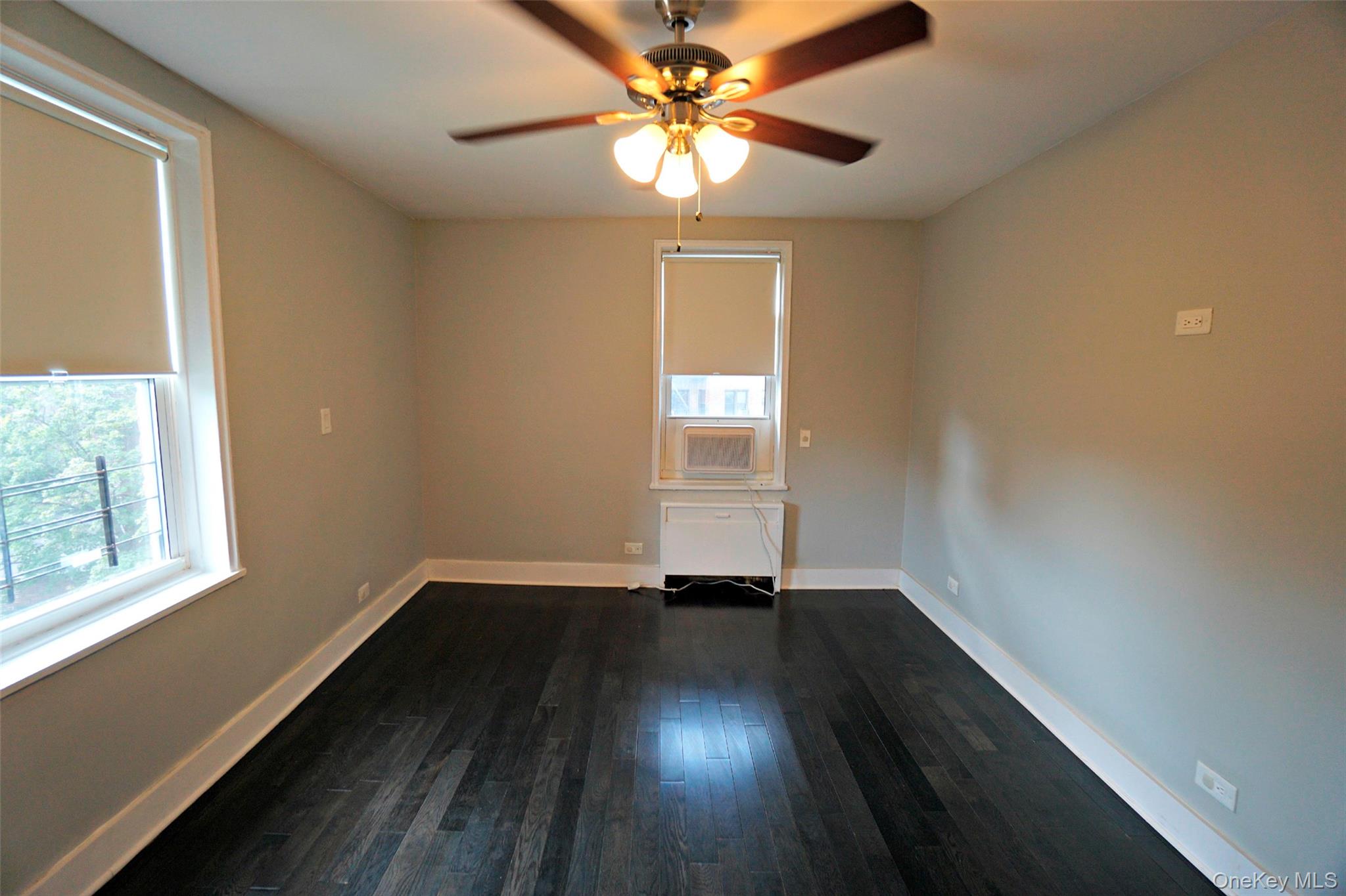 7281 113th Street, Unit 5F Queens, NY 11375 - Photo 10 of 22 a view of an empty room with wooden floor and a window