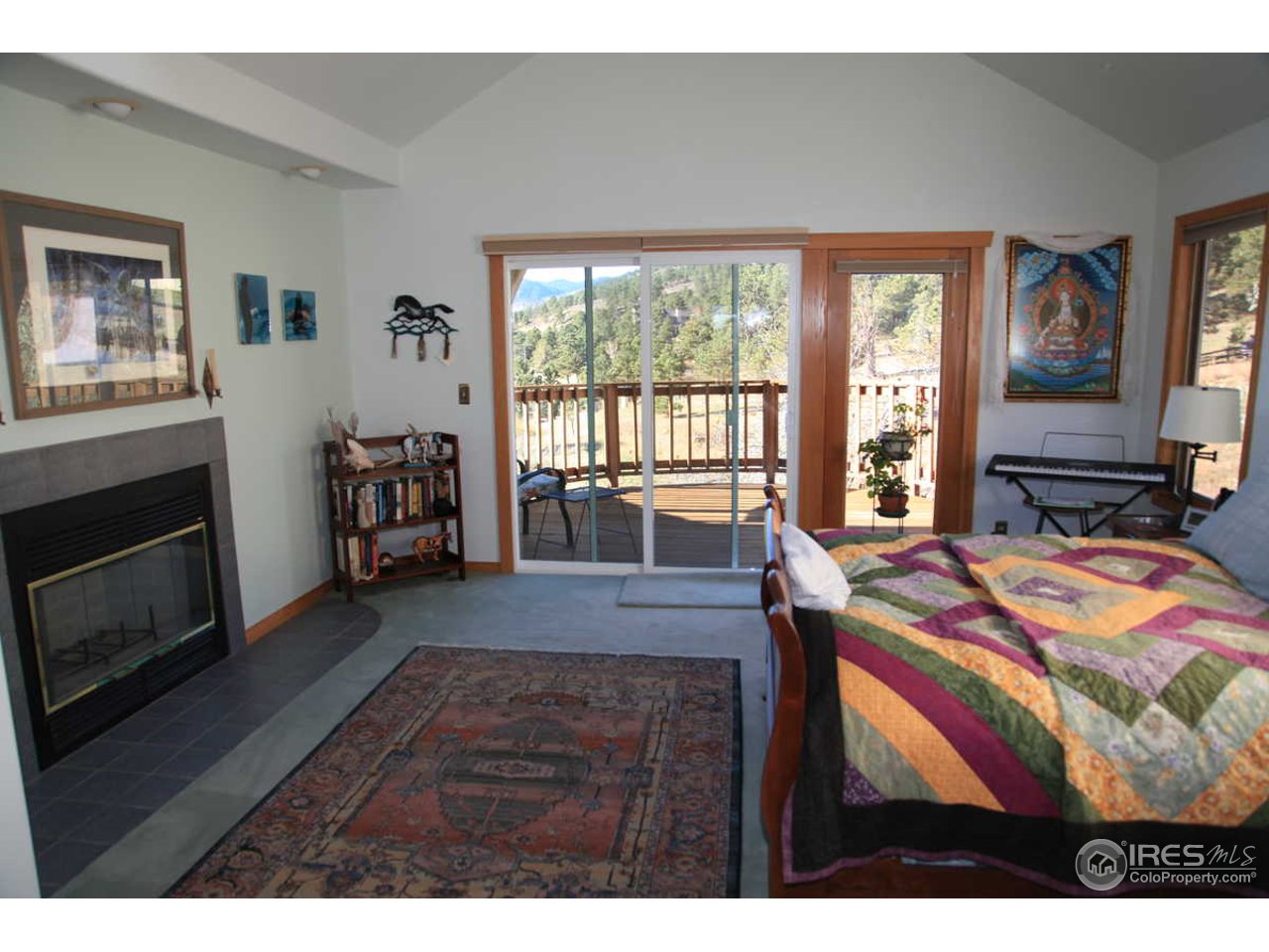 3061 Foothills Ranch Drive Boulder, CO 80302 - Photo 12 of 19 a bedroom with a bed a fireplace and a large window