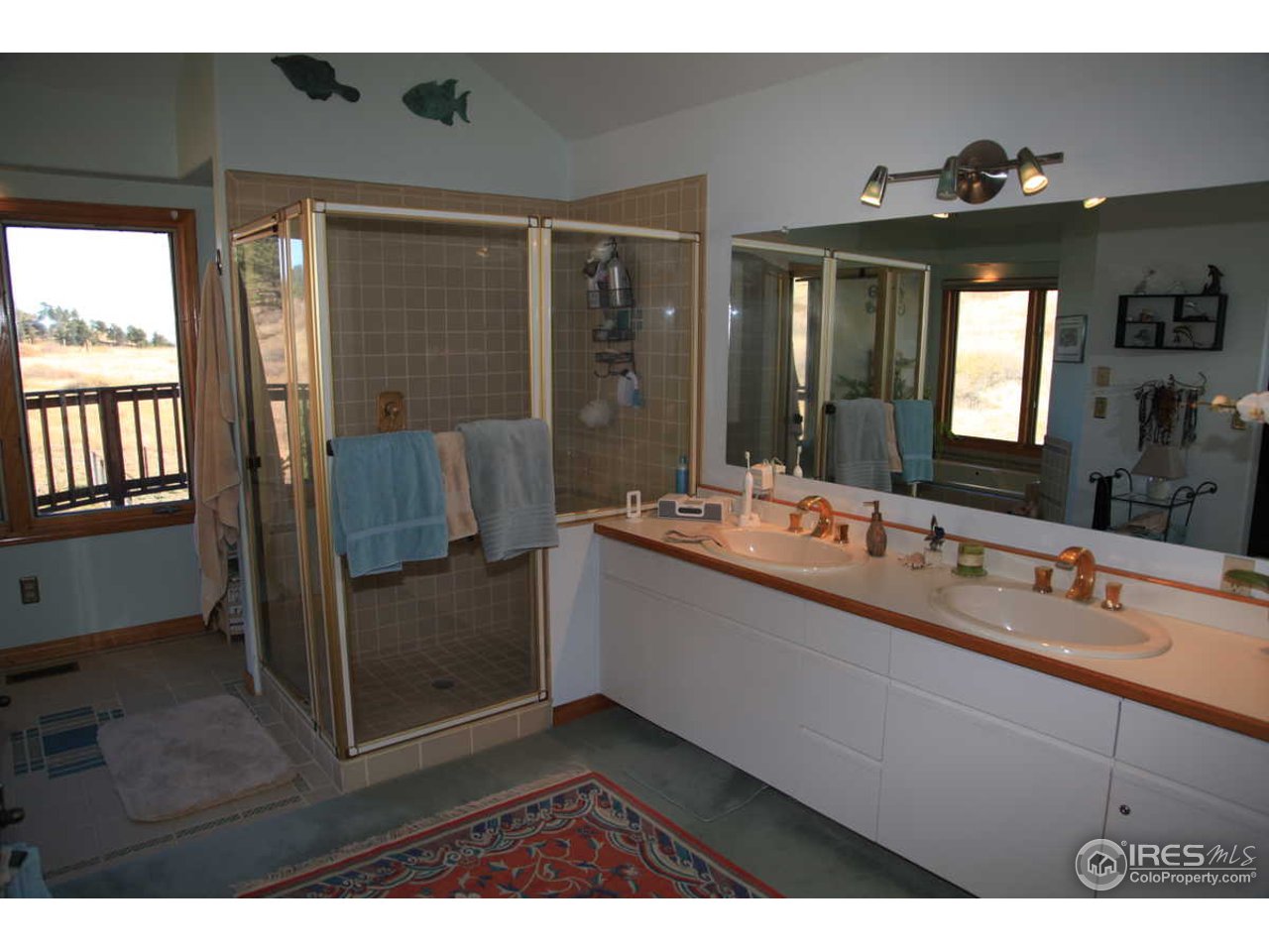 3061 Foothills Ranch Drive Boulder, CO 80302 - Photo 13 of 19 a bathroom with a sink a mirror and a bathtub