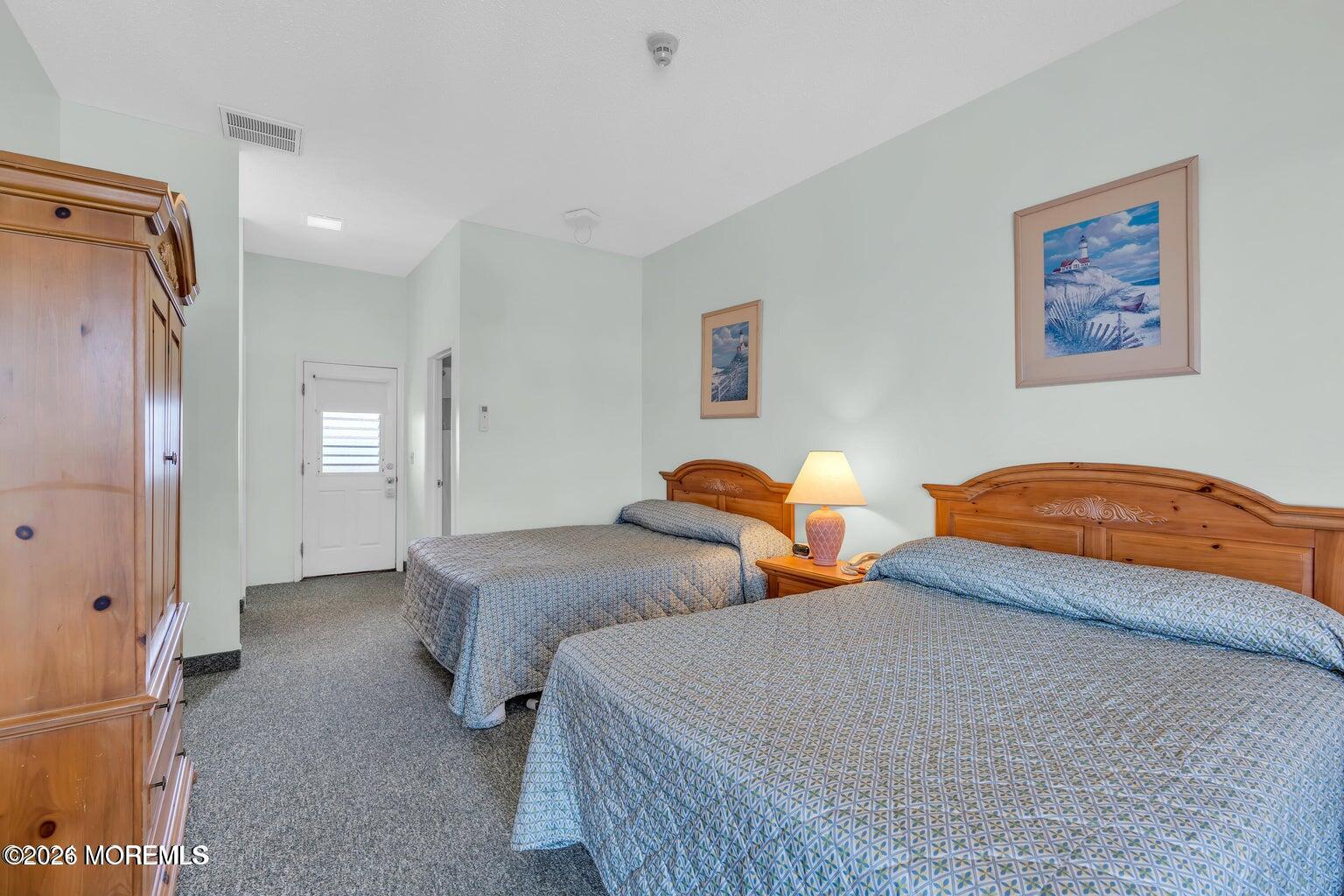 1008 Ocean Avenue Point Pleasant, NJ 08742 - Photo 11 of 29 a bedroom with two beds and painting on the wall