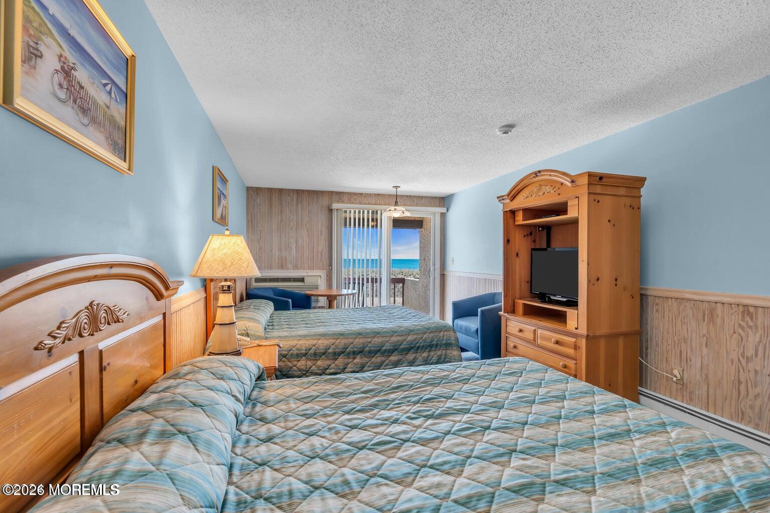 1008 Ocean Avenue Point Pleasant, NJ 08742 - Photo 15 of 29 a bed room with a bed and wooden floor