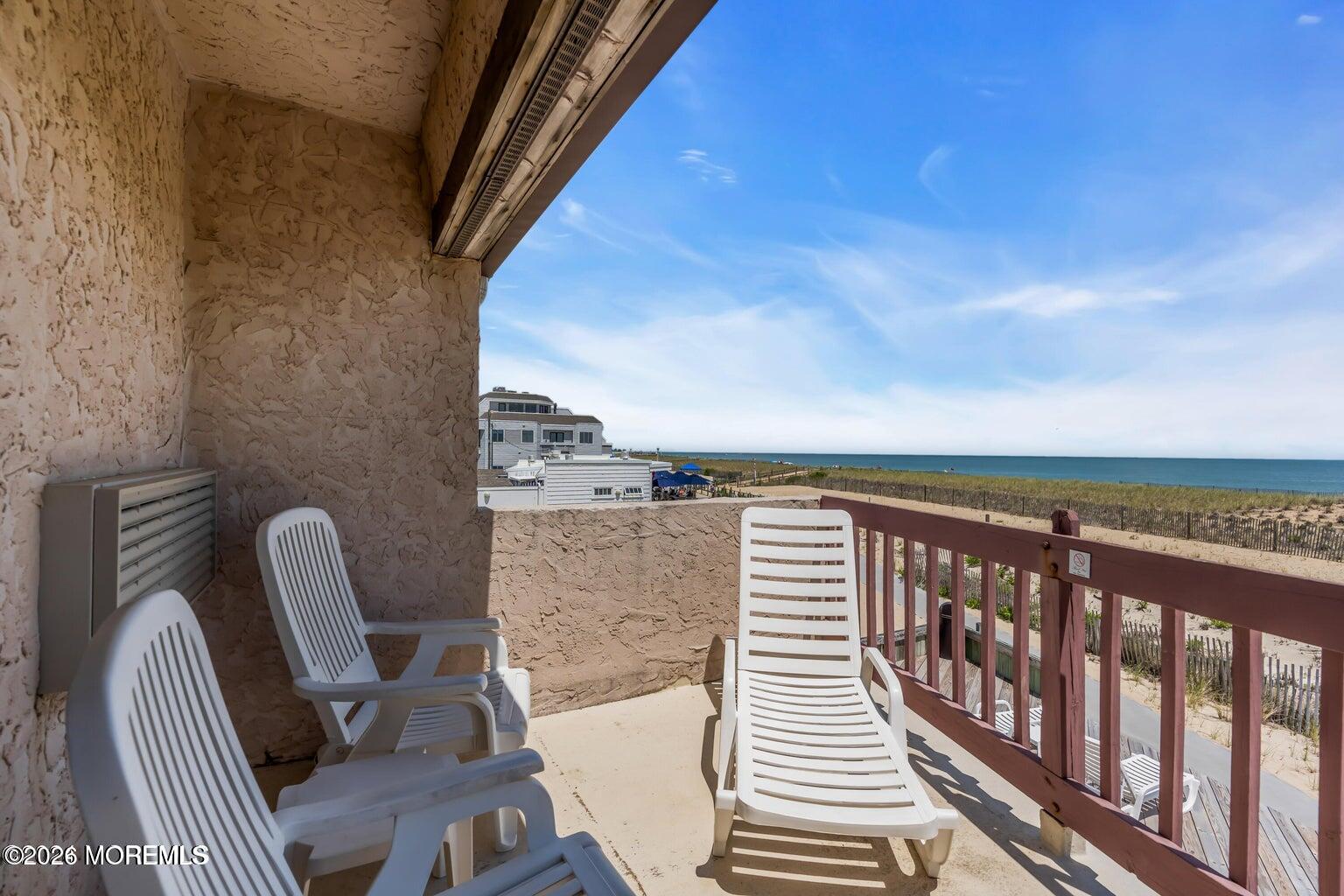 1008 Ocean Avenue Point Pleasant, NJ 08742 - Photo 17 of 29 a view of a balcony with chair and wooden floor