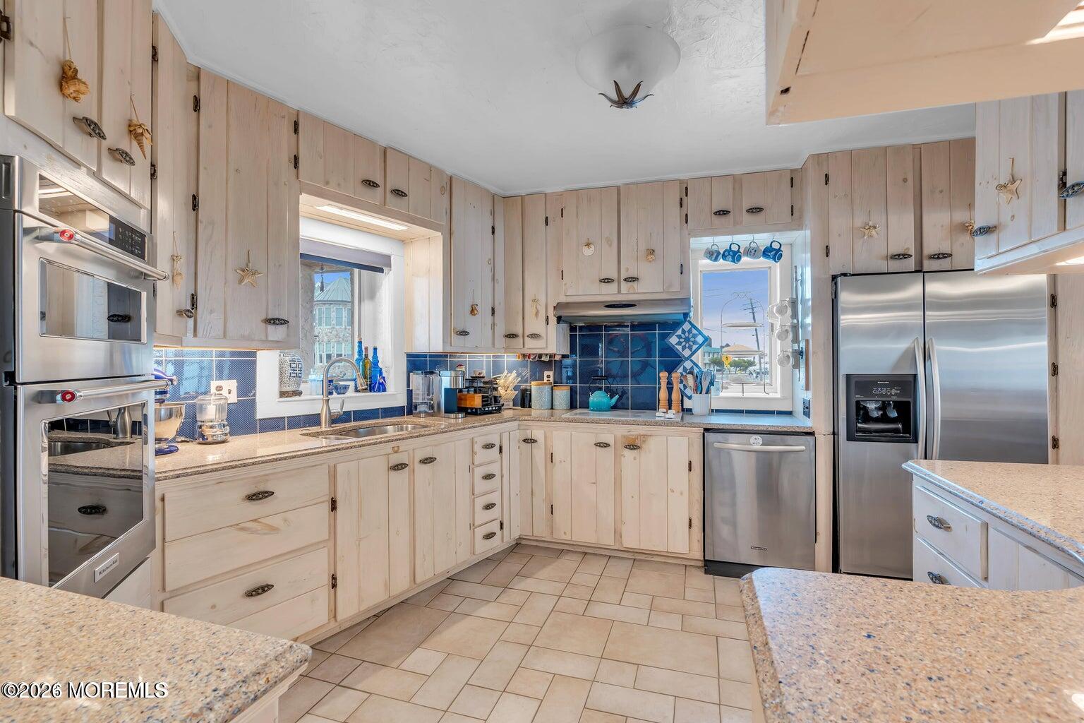 1008 Ocean Avenue Point Pleasant, NJ 08742 - Photo 22 of 29 a kitchen with cabinets and stainless steel appliances