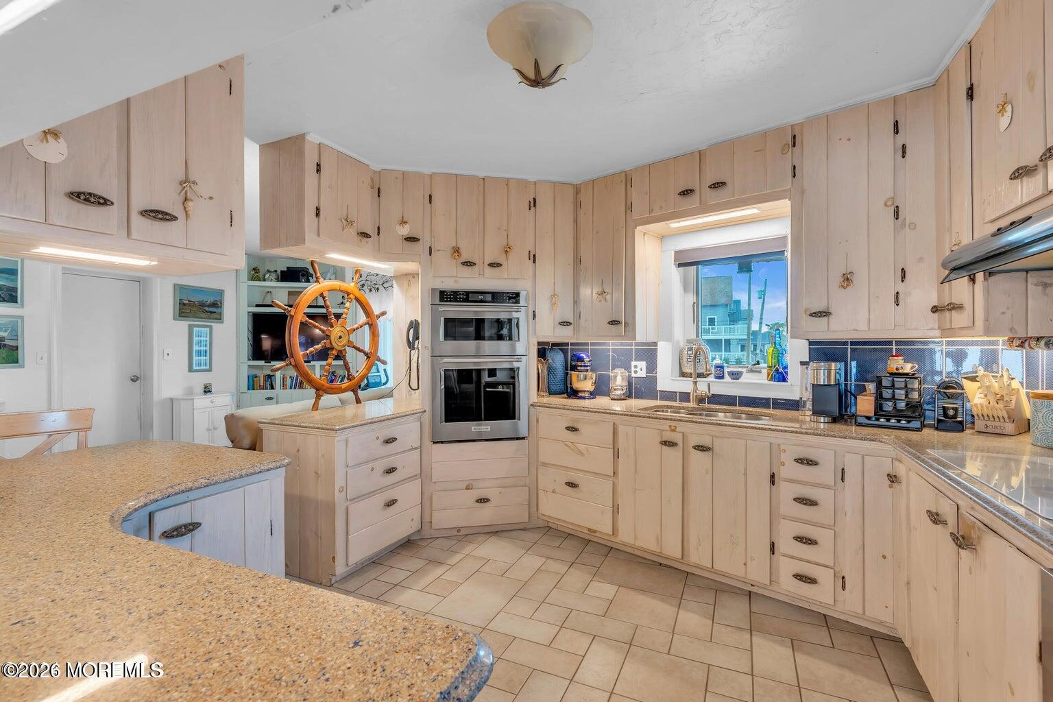 1008 Ocean Avenue Point Pleasant, NJ 08742 - Photo 23 of 29 a kitchen with white cabinets and appliances