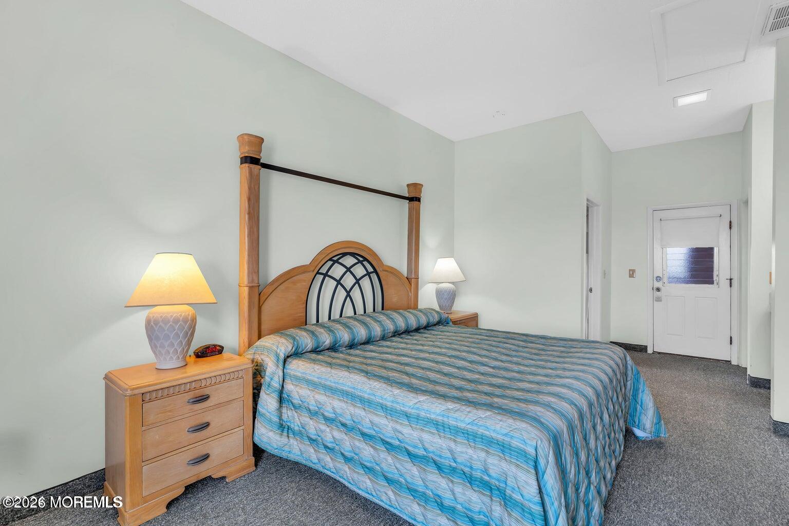 1008 Ocean Avenue Point Pleasant, NJ 08742 - Photo 7 of 29 a bedroom with a bed and a chandelier
