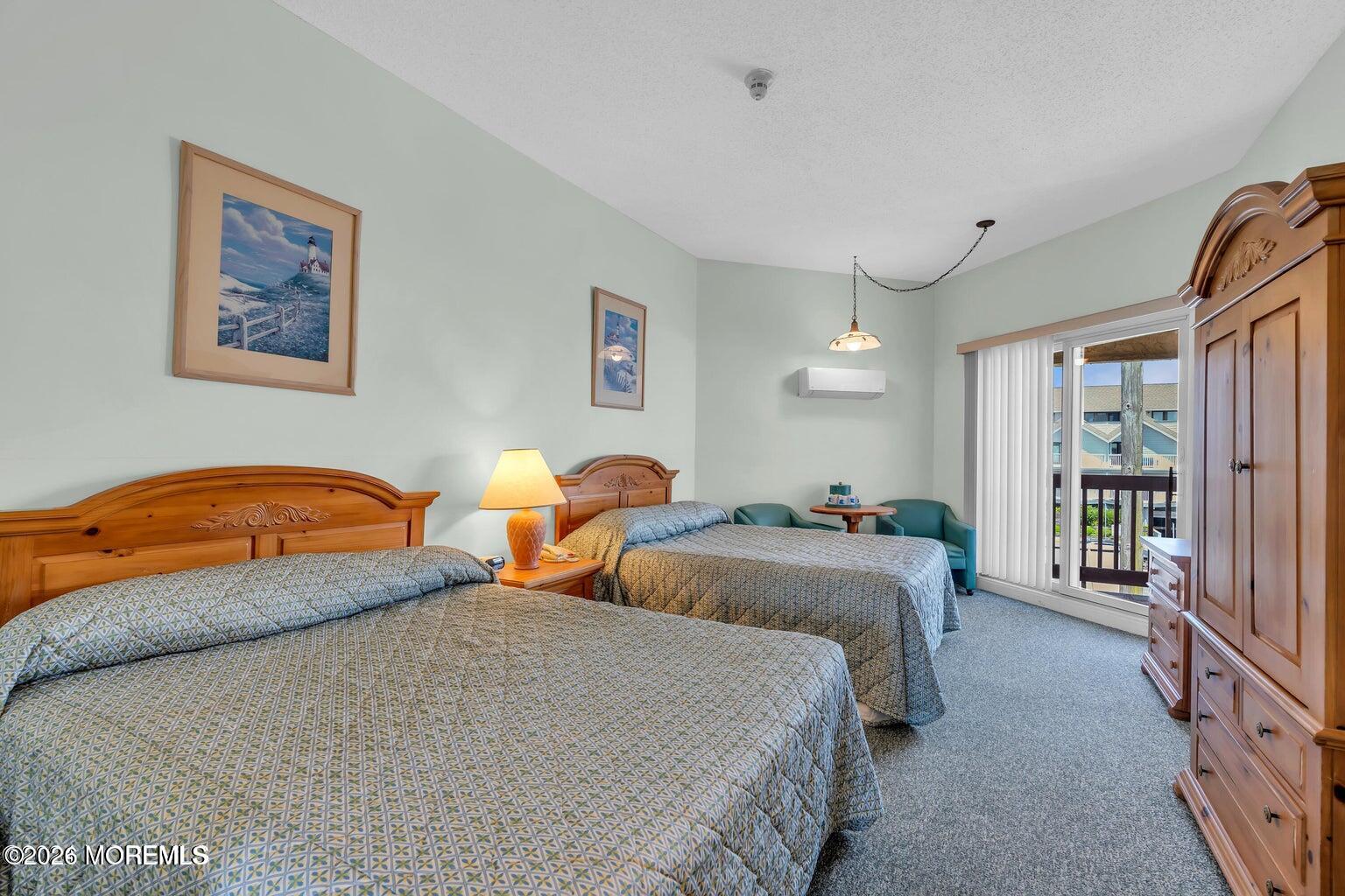 1008 Ocean Avenue Point Pleasant, NJ 08742 - Photo 9 of 29 a bedroom with two beds and a chandelier