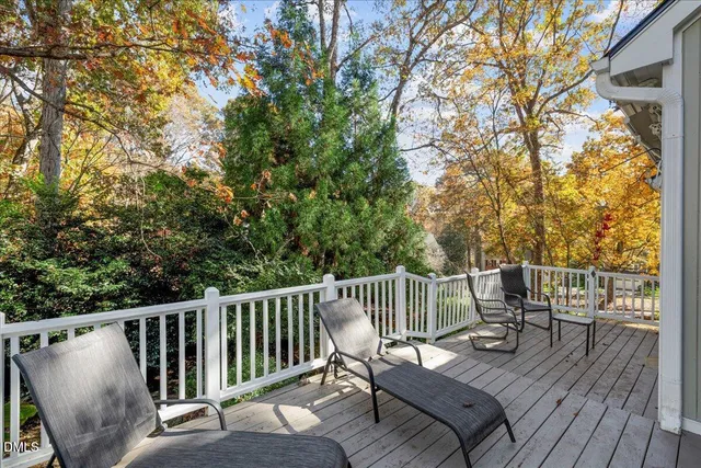 a view of a deck with chairs and wooden floor