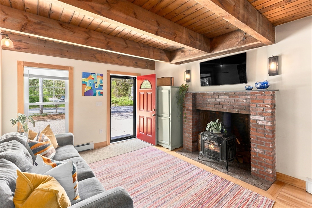 1020 Old Falmouth Road Barnstable, MA 02632 - Photo 26 of 42 a living room with furniture and a fireplace