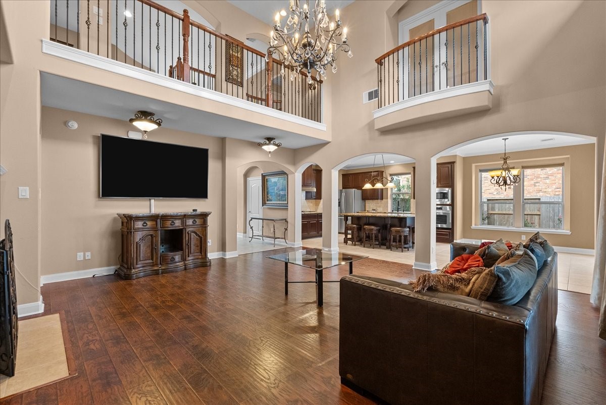 1358 Porta Rosa Lane League City, TX 77573 - Photo 14 of 48 The living room features a cozy fireplace and two-story ceilings