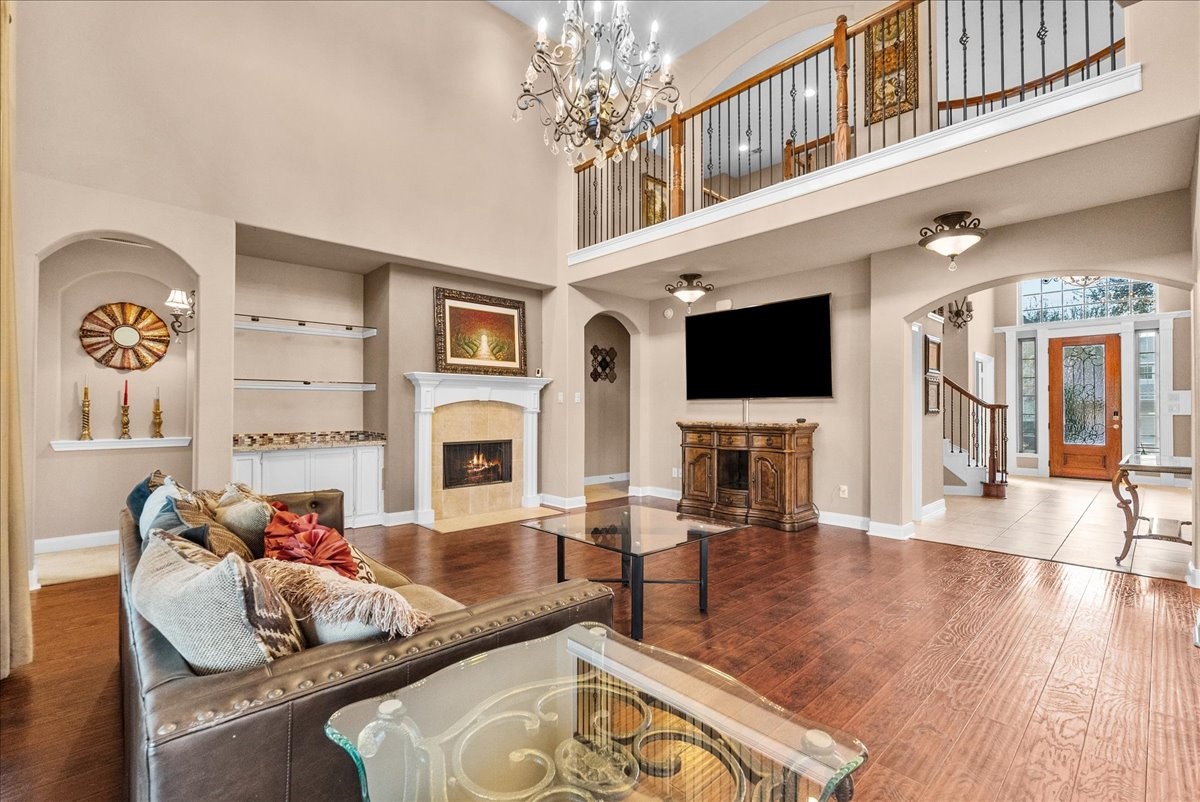 1358 Porta Rosa Lane League City, TX 77573 - Photo 16 of 48 The living room features a cozy fireplace and two-story ceilings