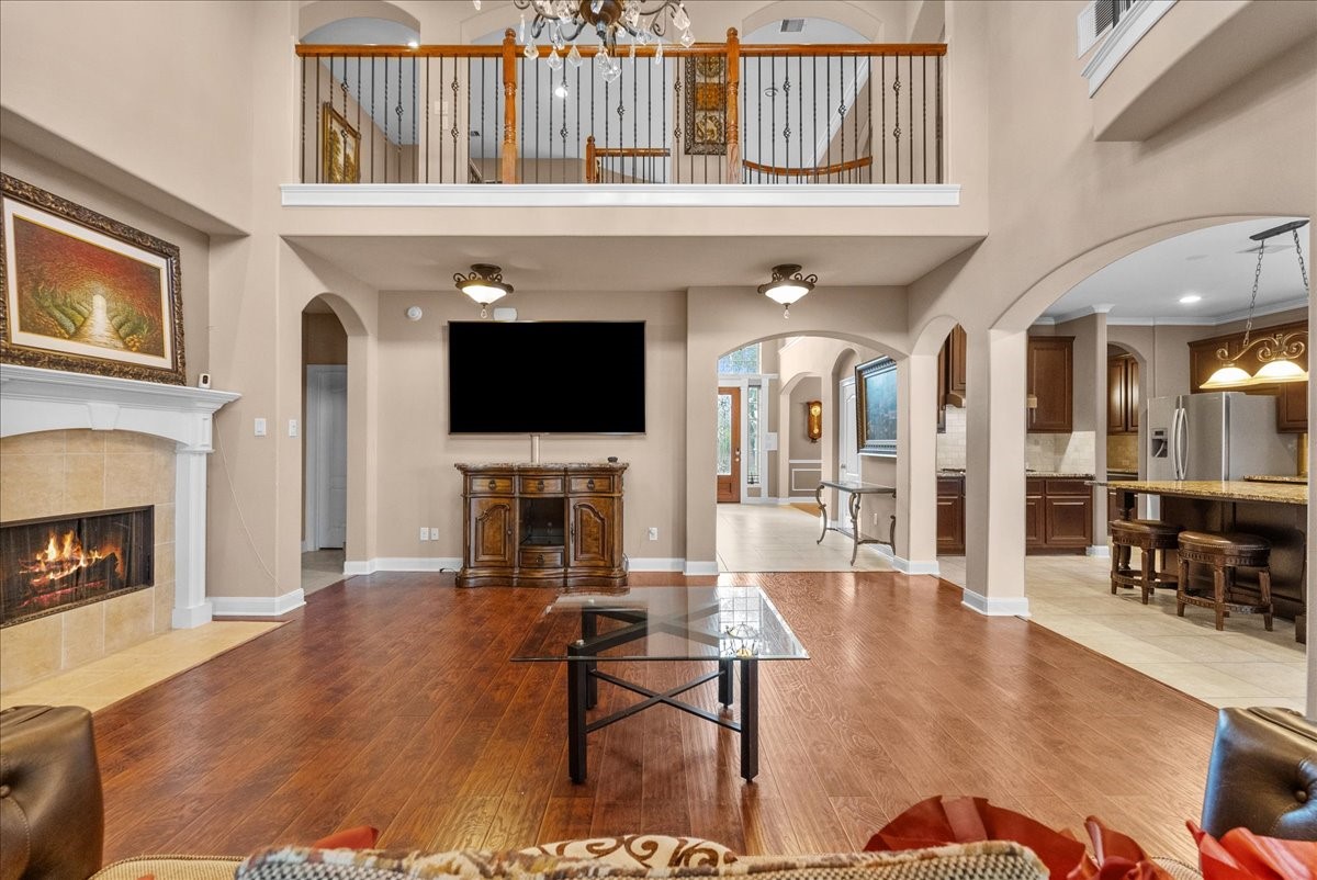 1358 Porta Rosa Lane League City, TX 77573 - Photo 17 of 48 The living room features a cozy fireplace and two-story ceilings